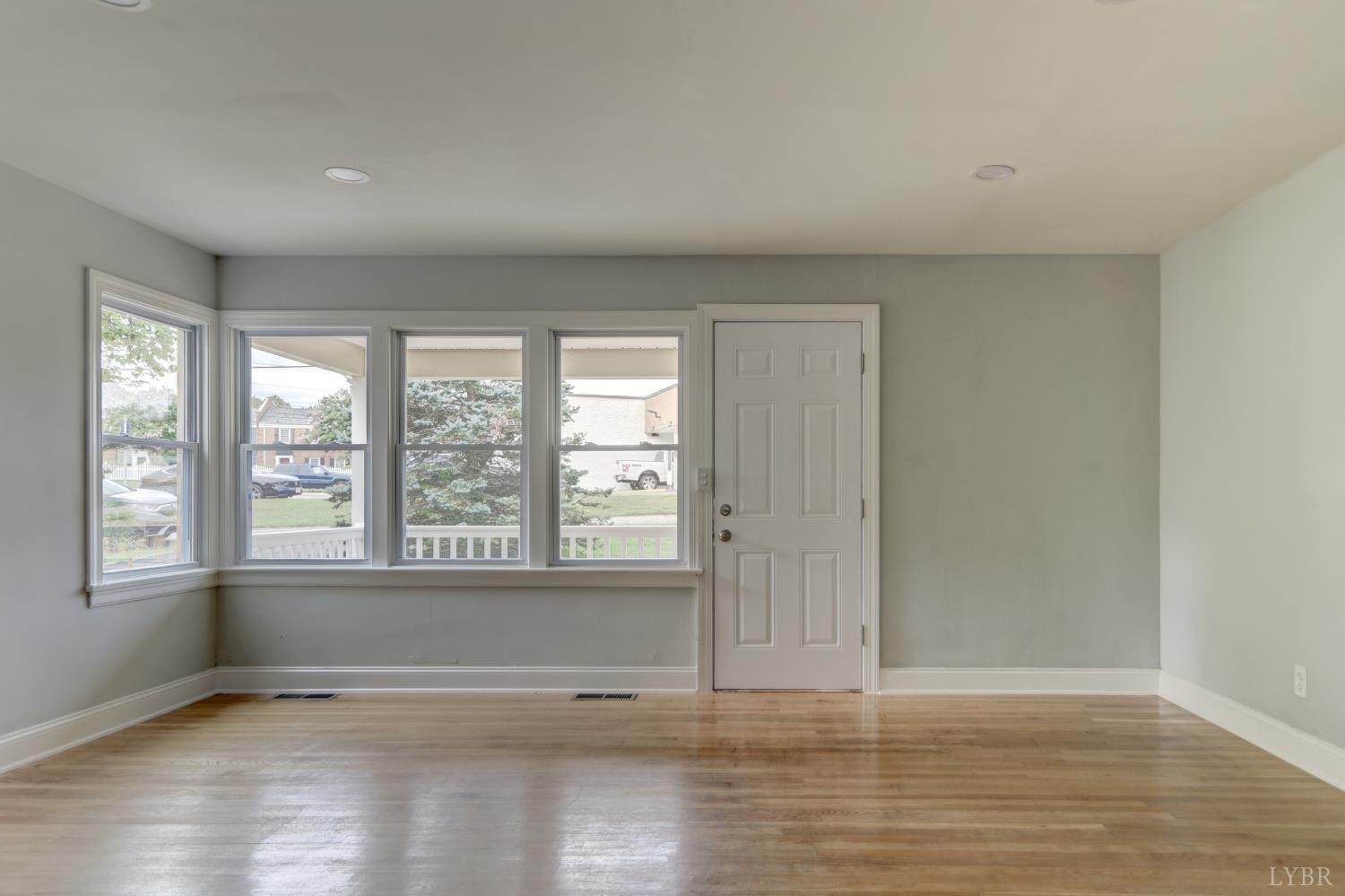 4724 Old Boonsboro Road Lynchburg, VA 24503 - Photo 5 of 39 a view of an empty room with wooden floor and a window