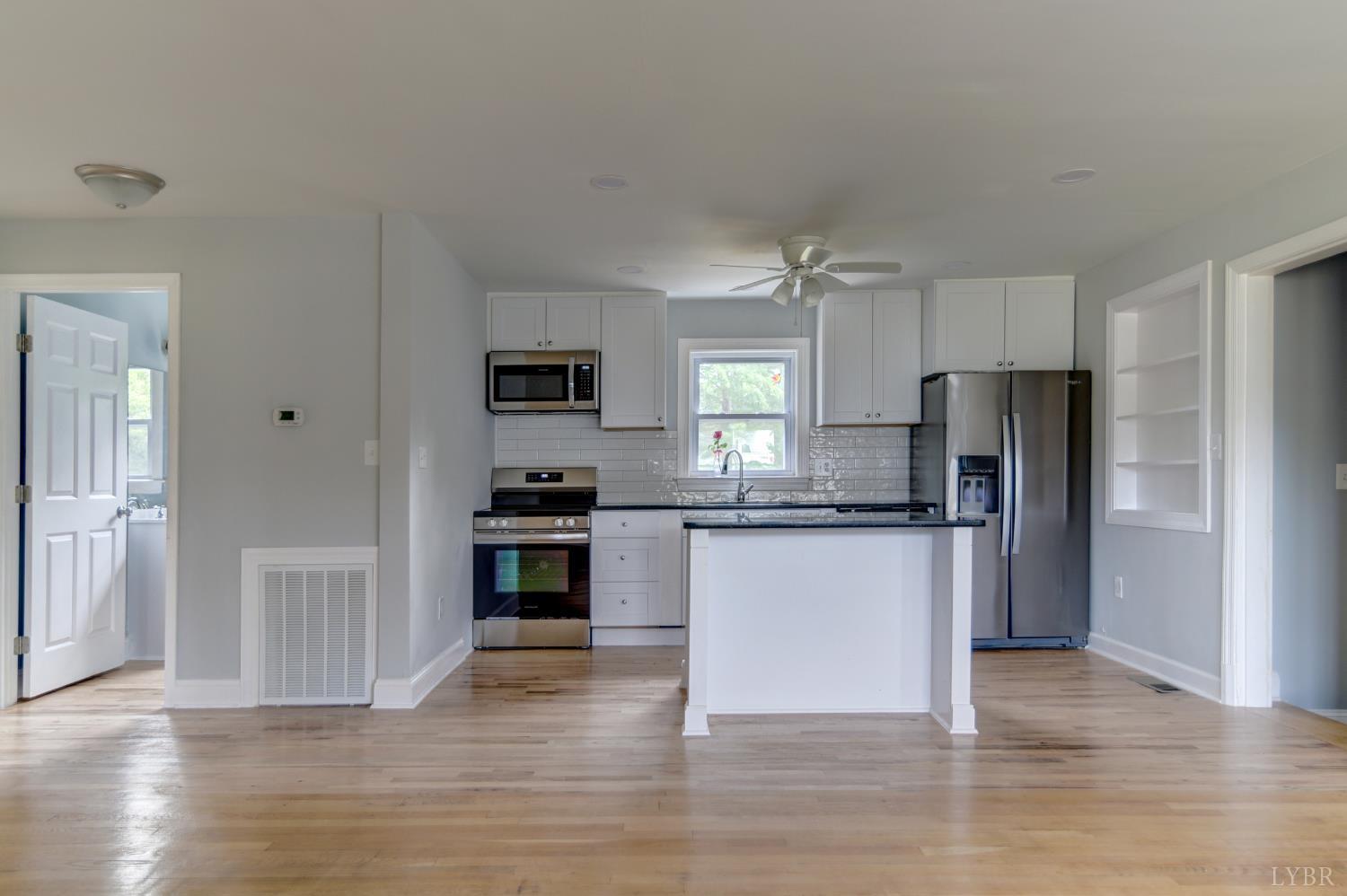 4724 Old Boonsboro Road Lynchburg, VA 24503 - Photo 6 of 39 a kitchen with granite countertop a refrigerator and wooden floors