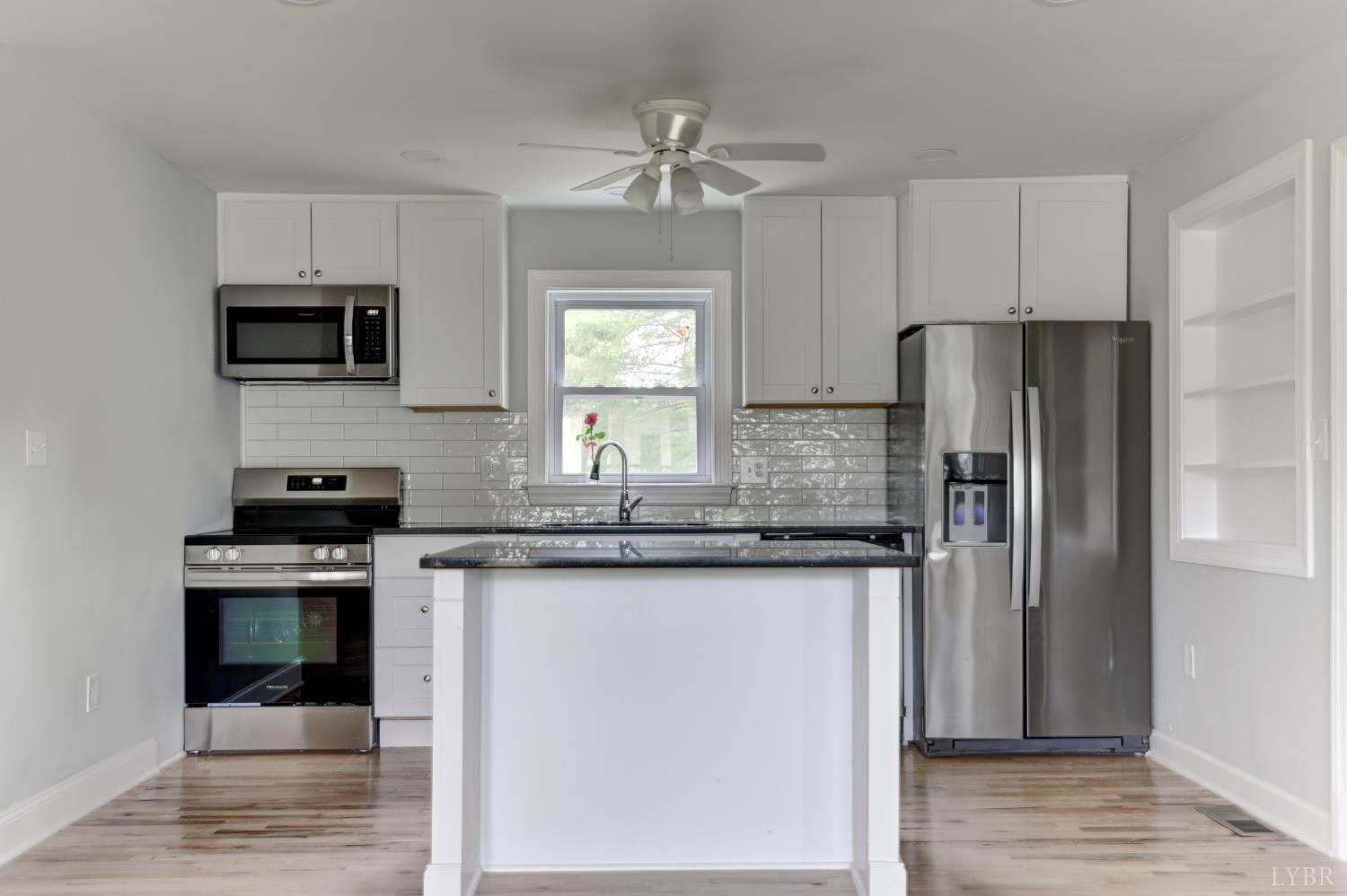 4724 Old Boonsboro Road Lynchburg, VA 24503 - Photo 7 of 39 a kitchen with stainless steel appliances granite countertop a stove a refrigerator and a microwave