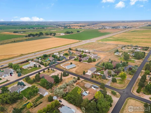 an aerial view of ocean and residential houses with outdoor space