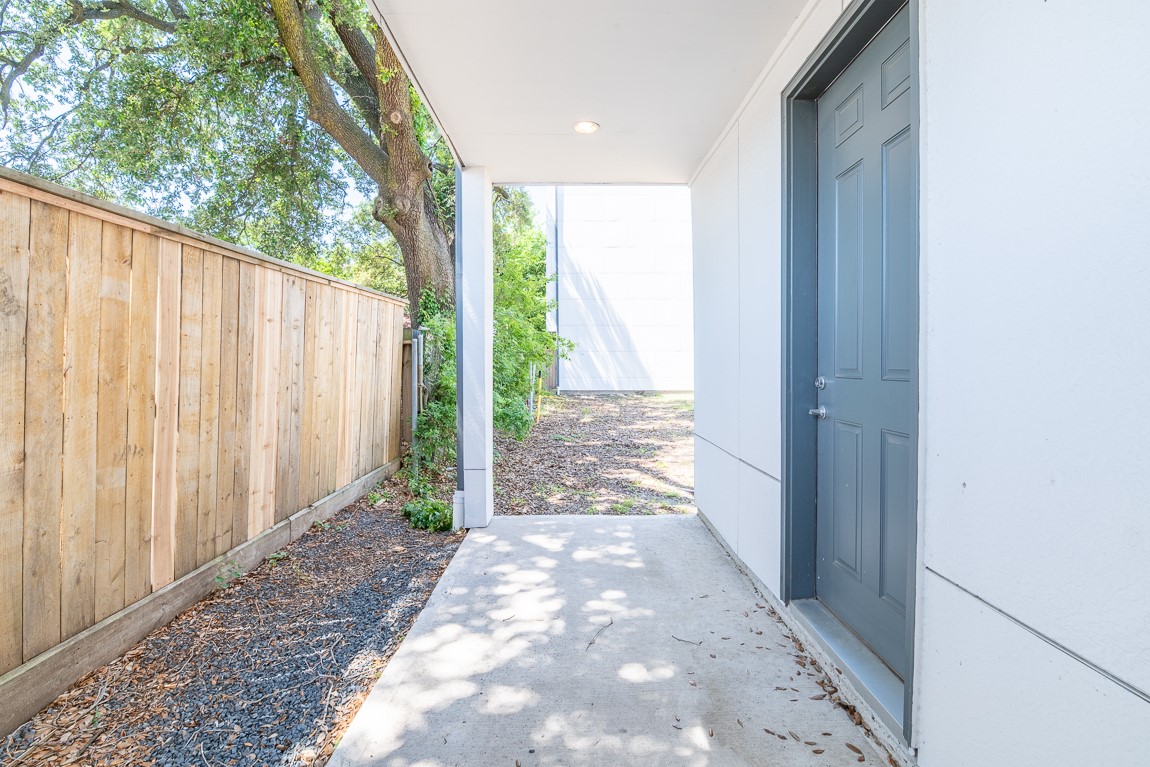 2414 D Canal Street Houston, TX 77003 - Photo 9 of 16 Back porch area is now fenced in and has a gate. Nice area from the garage or the 1st floor bedroom. Garage through the door has a flex area for a workshop/ workout area, storage, etc.