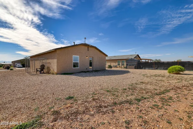 a view of a dry yard with a house