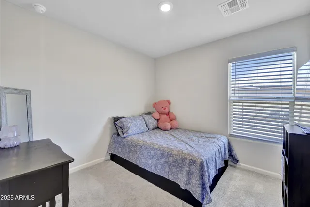 a bedroom with a bed and a desk