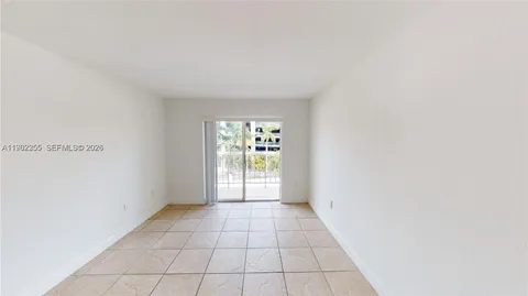 a view of a hallway with wooden floor and chandelier