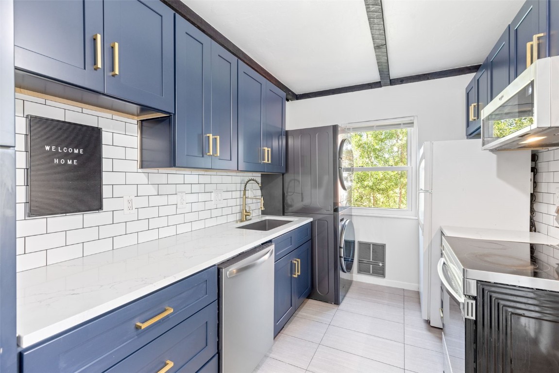 a kitchen with a sink cabinets and window