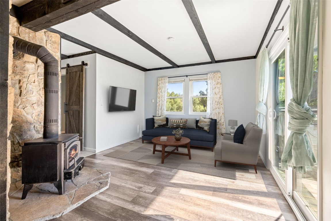 8011 Ryan Gulch Road, Unit B2 Silverthorne, CO 80498 - Photo 12 of 27 a living room with furniture a flat screen tv and a window
