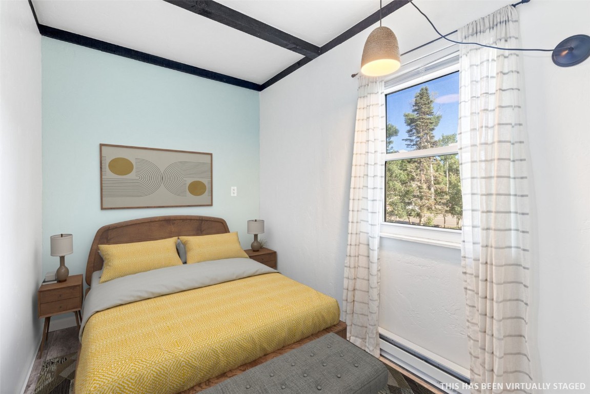 8011 Ryan Gulch Road, Unit B2 Silverthorne, CO 80498 - Photo 16 of 27 a bedroom with a bed and a window