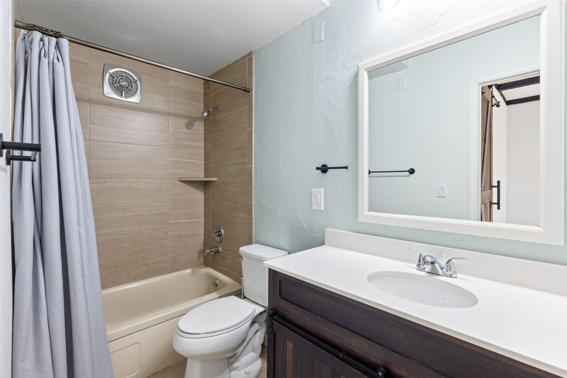 8011 Ryan Gulch Road, Unit B2 Silverthorne, CO 80498 - Photo 17 of 27 a bathroom with a granite countertop sink toilet mirror and shower