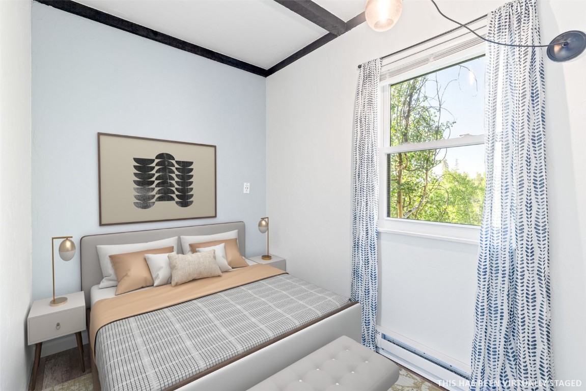 8011 Ryan Gulch Road, Unit B2 Silverthorne, CO 80498 - Photo 21 of 27 a bedroom with a bed and a window