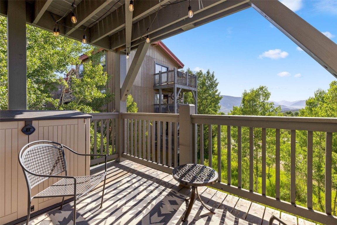 8011 Ryan Gulch Road, Unit B2 Silverthorne, CO 80498 - Photo 22 of 27 a view of balcony with wooden floor and fence