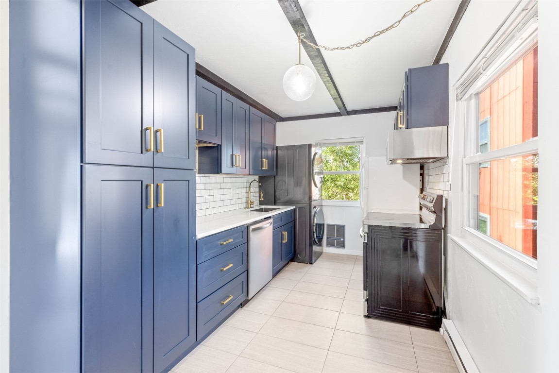 8011 Ryan Gulch Road, Unit B2 Silverthorne, CO 80498 - Photo 3 of 27 a kitchen with stainless steel appliances granite countertop a refrigerator a sink dishwasher a kitchen island with cabinets and wooden floor