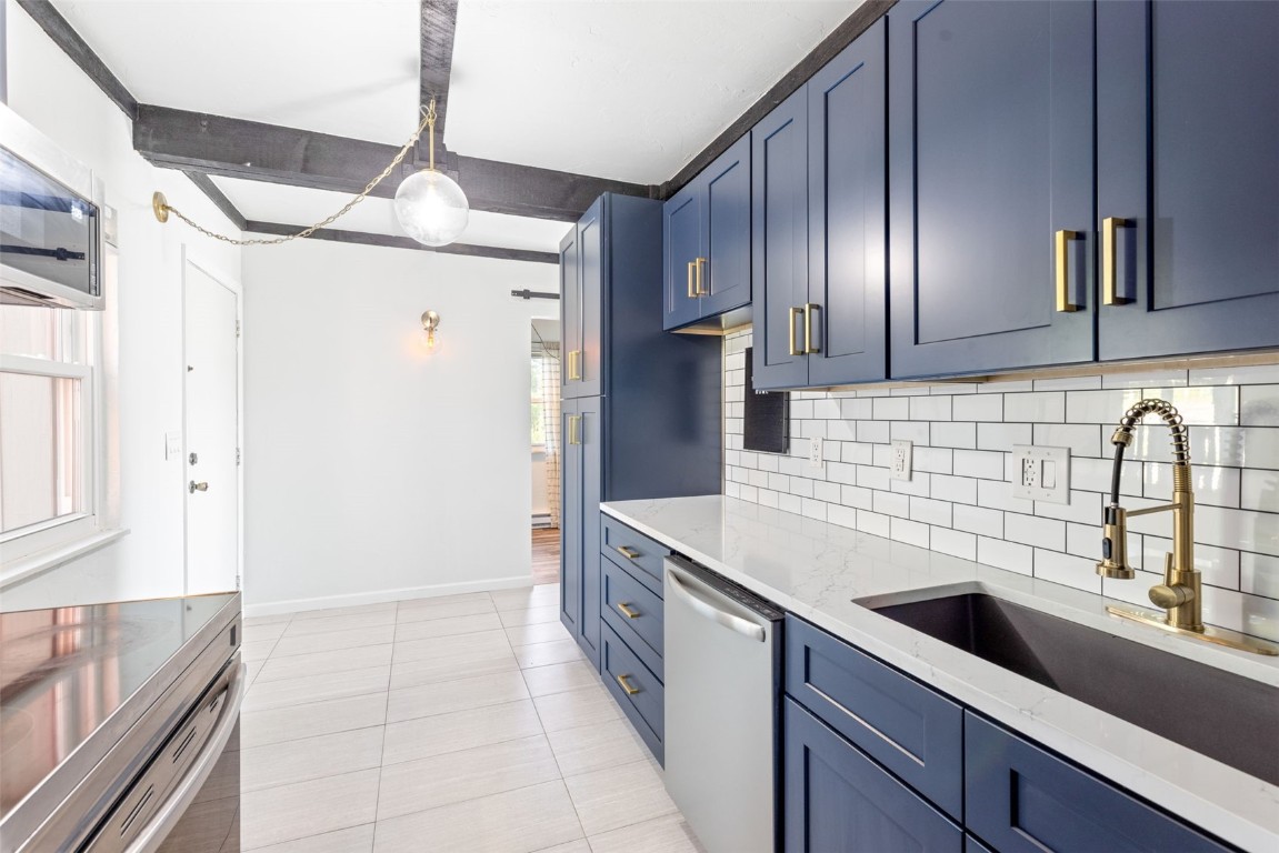 8011 Ryan Gulch Road, Unit B2 Silverthorne, CO 80498 - Photo 4 of 27 a kitchen with stainless steel appliances a sink stove and refrigerator
