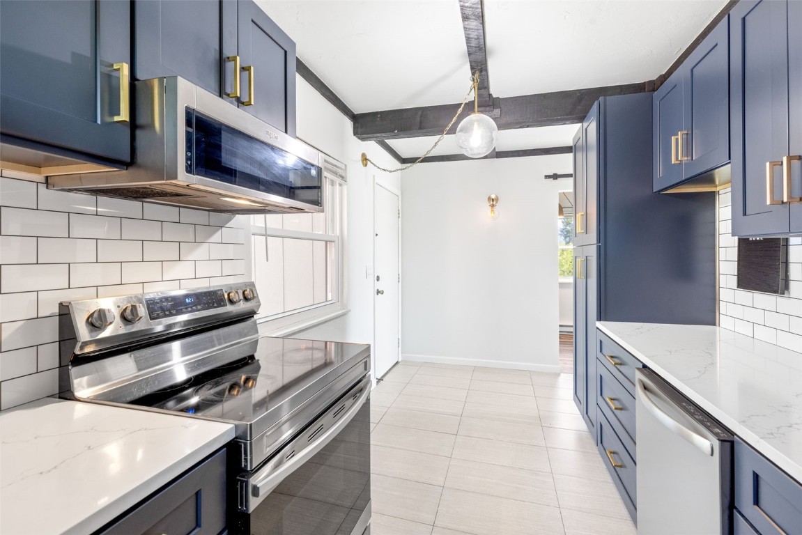8011 Ryan Gulch Road, Unit B2 Silverthorne, CO 80498 - Photo 5 of 27 a kitchen with stainless steel appliances granite countertop a stove and a refrigerator