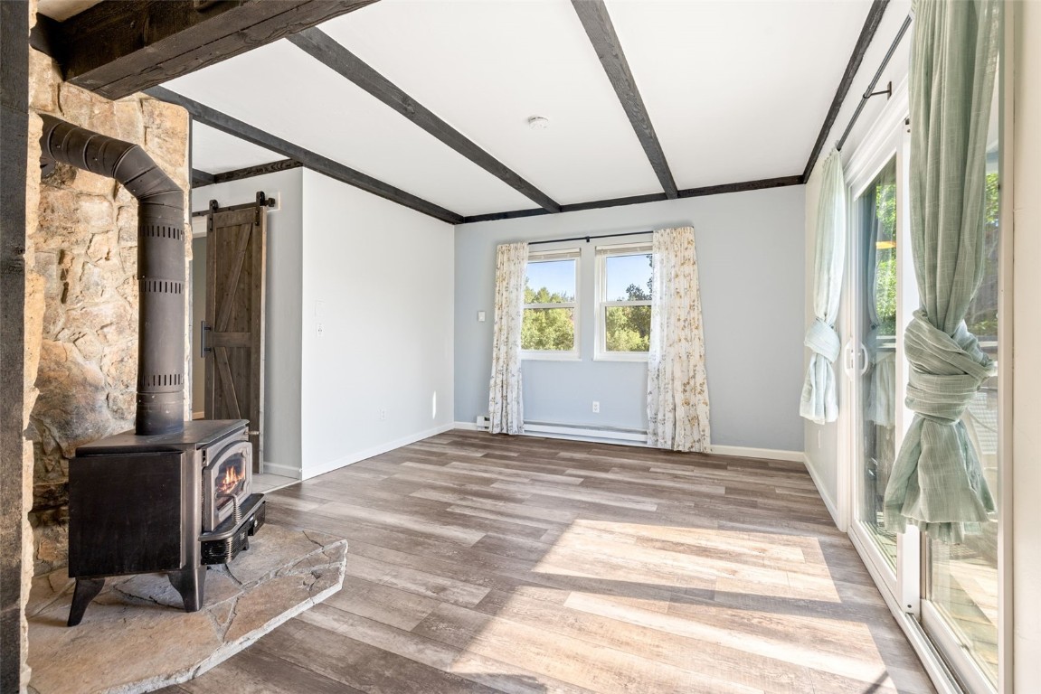 8011 Ryan Gulch Road, Unit B2 Silverthorne, CO 80498 - Photo 10 of 27 a view of empty room with wooden floor and fan