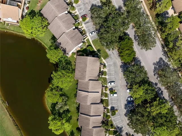 an aerial view of a house with a garden and lake view