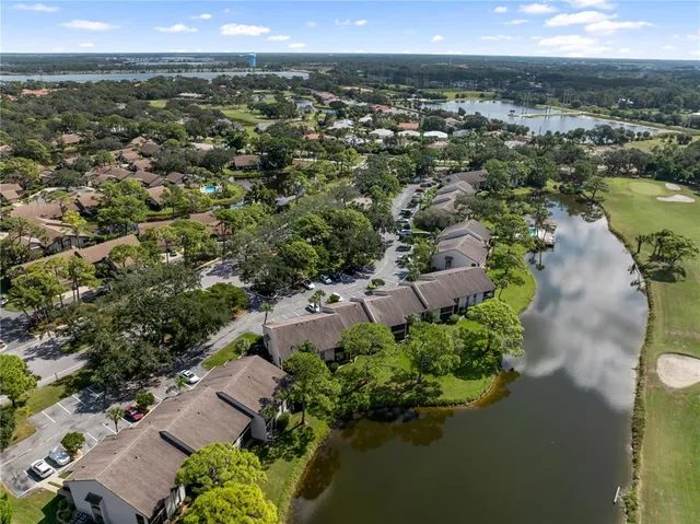 a view of a patio with lawn chairs next to a yard