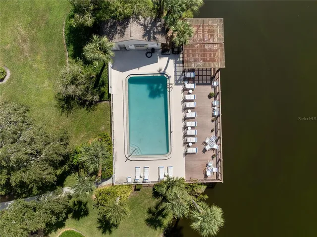 an aerial view of a house with a garden and lake view