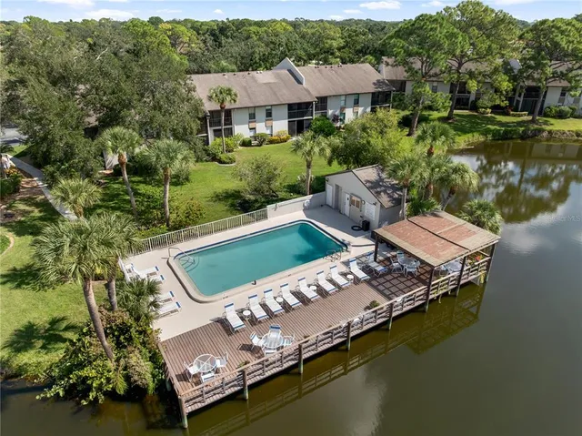 an aerial view of a house with garden space and street view