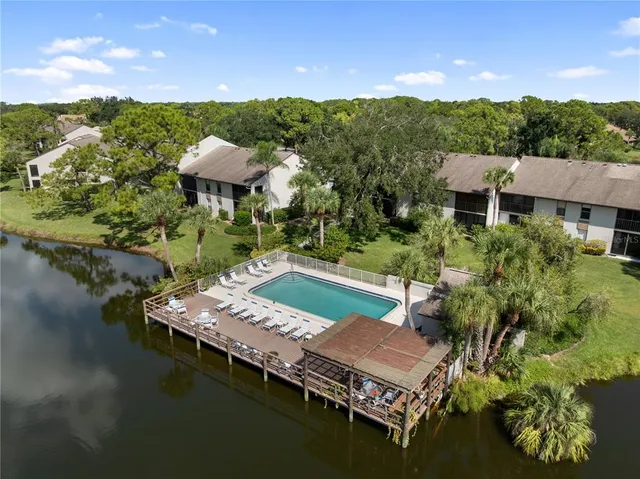 an aerial view of a house with yard swimming pool and outdoor seating