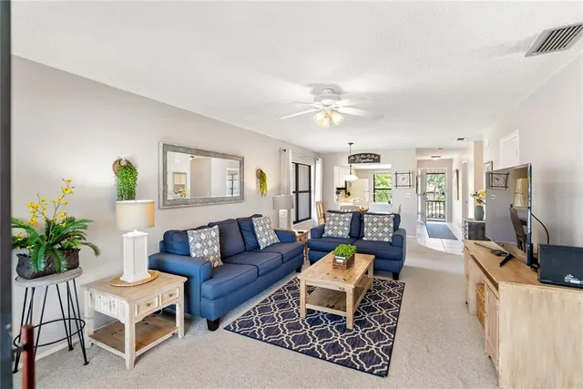 a dining room with furniture a chandelier and a rug