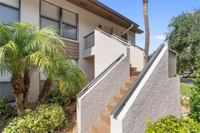a white toilet sitting next to a white sink and vanity