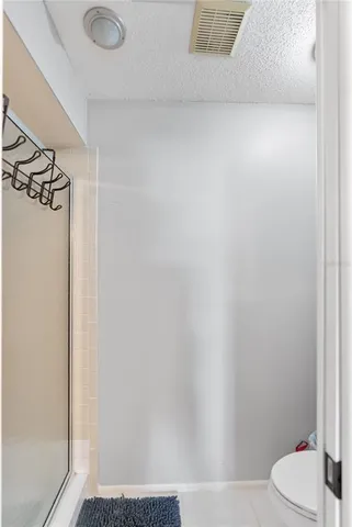a bathroom with a bathtub shower sink and toilet