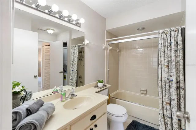 a living room with furniture a flat screen tv and a large window