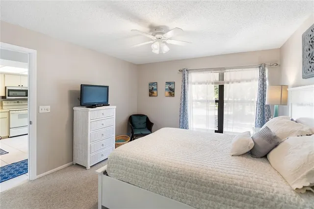 a dining room with furniture a chandelier and wooden floor
