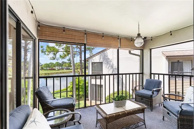 a bedroom with a large bed and a chandelier fan