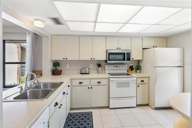 a bathroom with a double vanity sink toilet mirror and shower