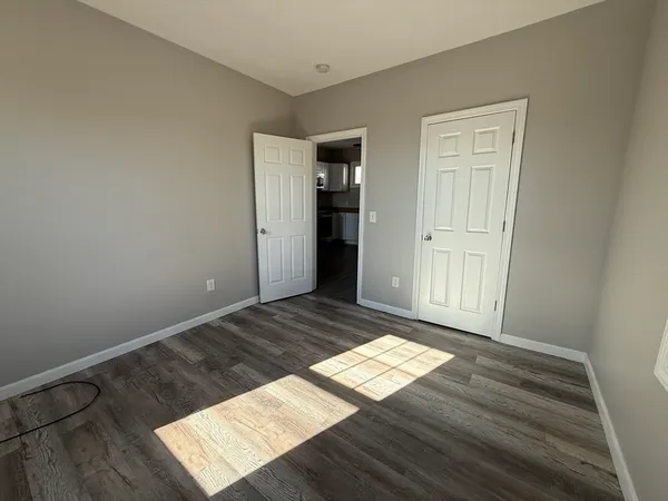 a view of wooden floor and windows in a room