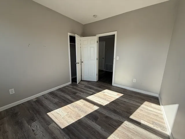a view of wooden floor in an empty room