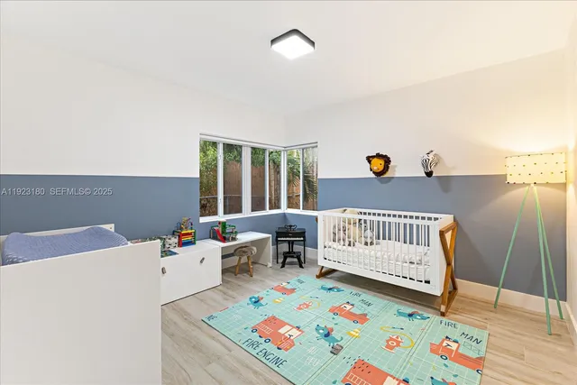 a bedroom with furniture and a baby crib