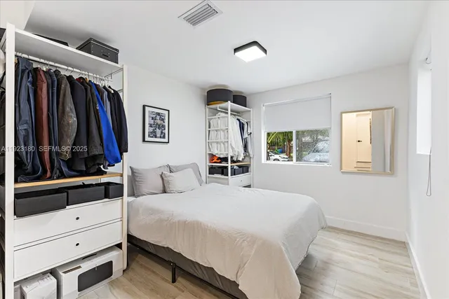 a bedroom with a large bed and a window