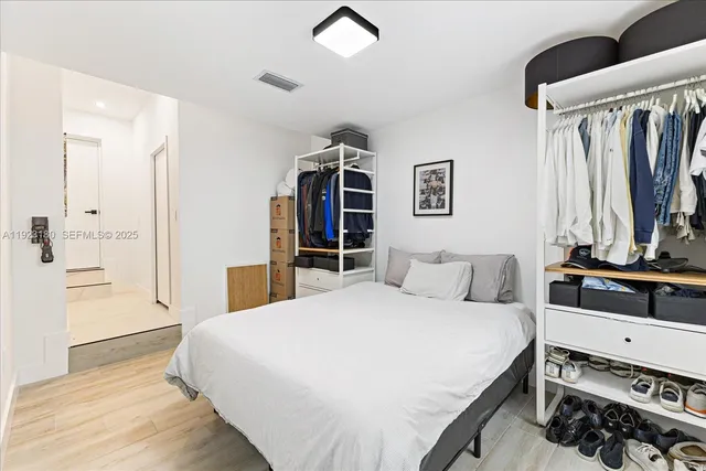 a bedroom with a large bed and a chandelier