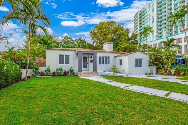 a front view of a house with a garden