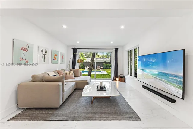 a living room with furniture large window and flat screen tv
