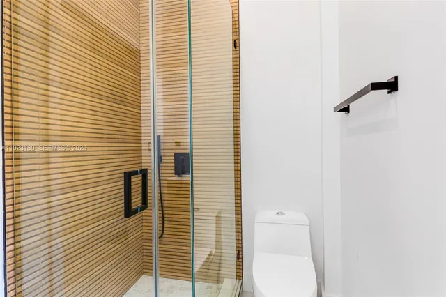 a bathroom with a toilet and a shower