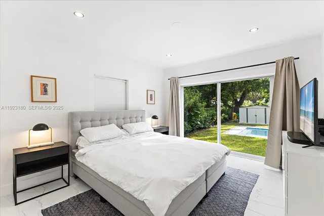 a bedroom with a bed and a view of balcony