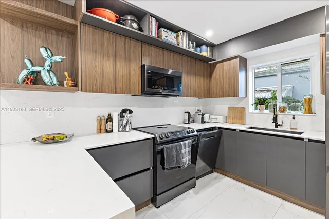 a kitchen with stainless steel appliances granite countertop a sink stove and cabinets