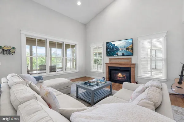 a dining room with furniture a chandelier and wooden floor
