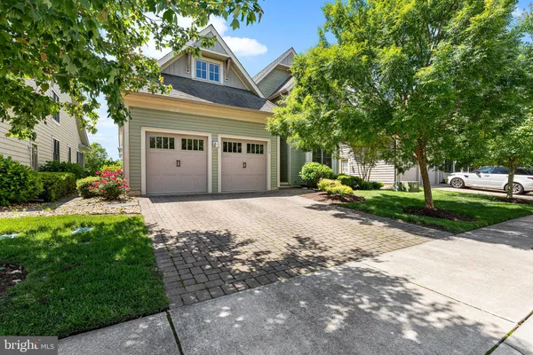 an aerial view of a house with garden space and ocean view