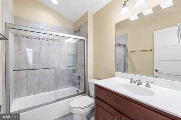 a view of swimming pool with a table and chairs under an umbrella