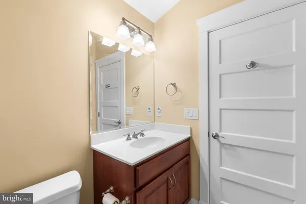 a living room with furniture a fireplace and a dining table with wooden floor