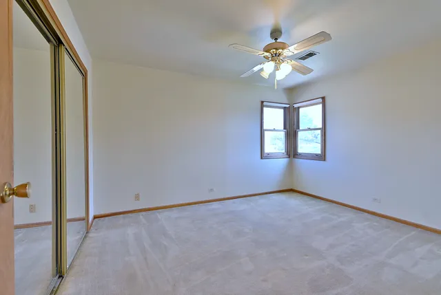 a view of a chandelier fan and windows