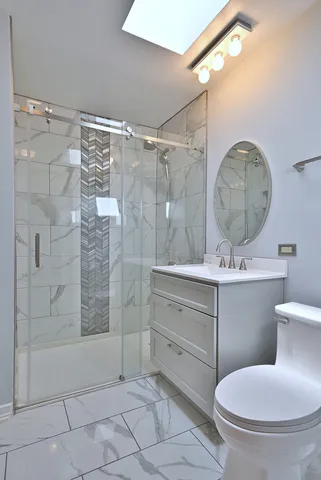 a bathroom with a toilet sink and shower