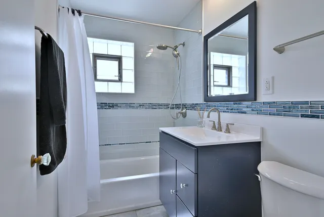 a bathroom with a sink toilet and shower