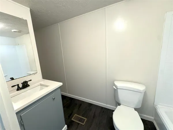 a bathroom with a toilet a sink and a mirror