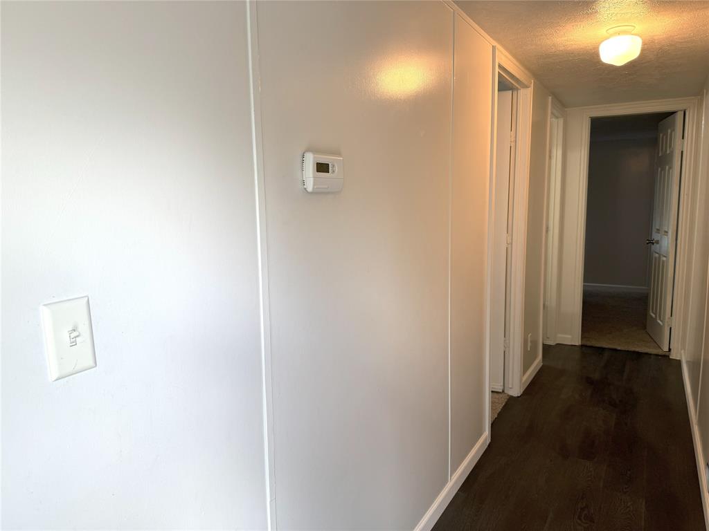 2087 Meadow Road Kerens, TX 75144 - Photo 15 of 28 a view of a hallway with a wooden floor