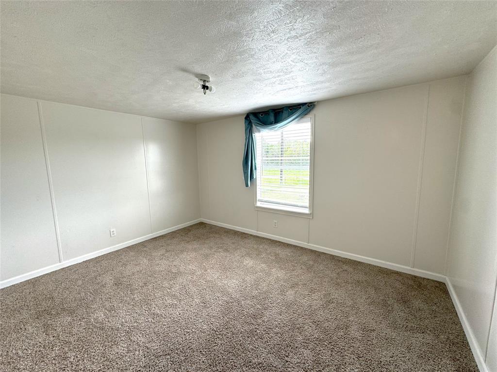 2087 Meadow Road Kerens, TX 75144 - Photo 17 of 28 an empty room with windows